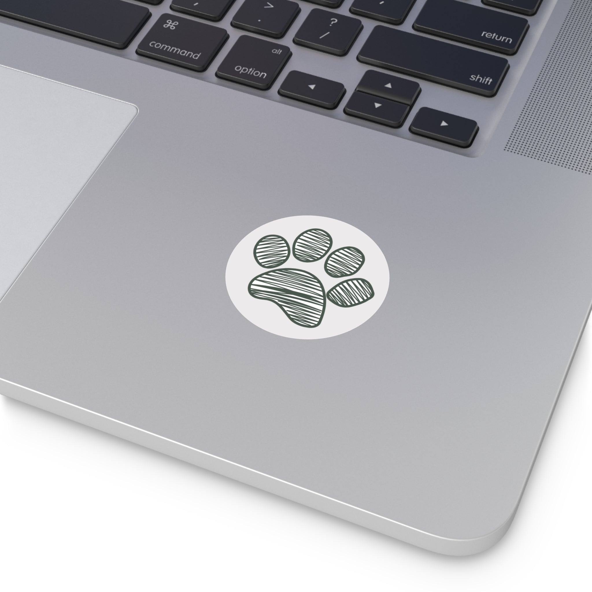 Laptop with a paw print sticker on the palm rest area