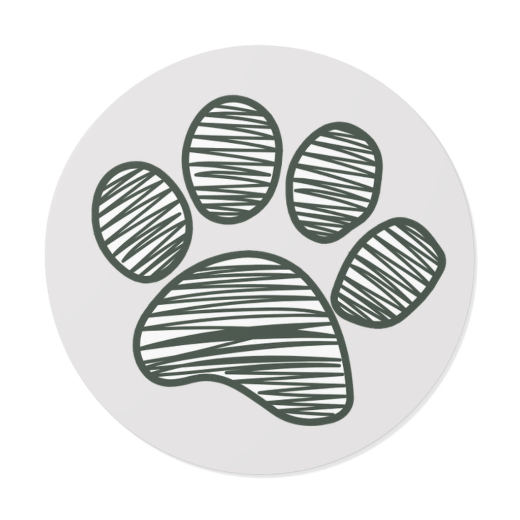 Circular object with a green paw print design on a white background